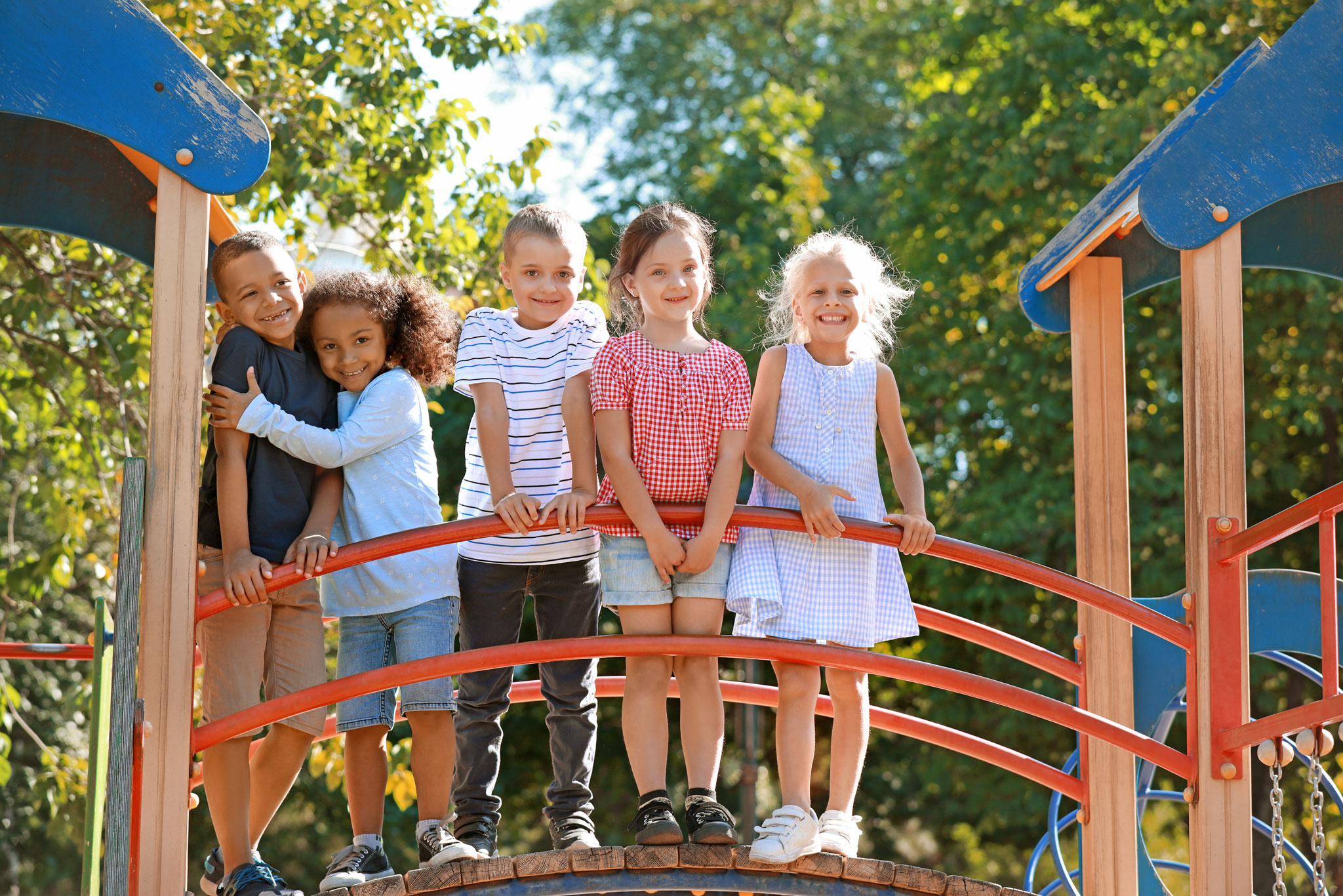 Happy kids on playground equipment.